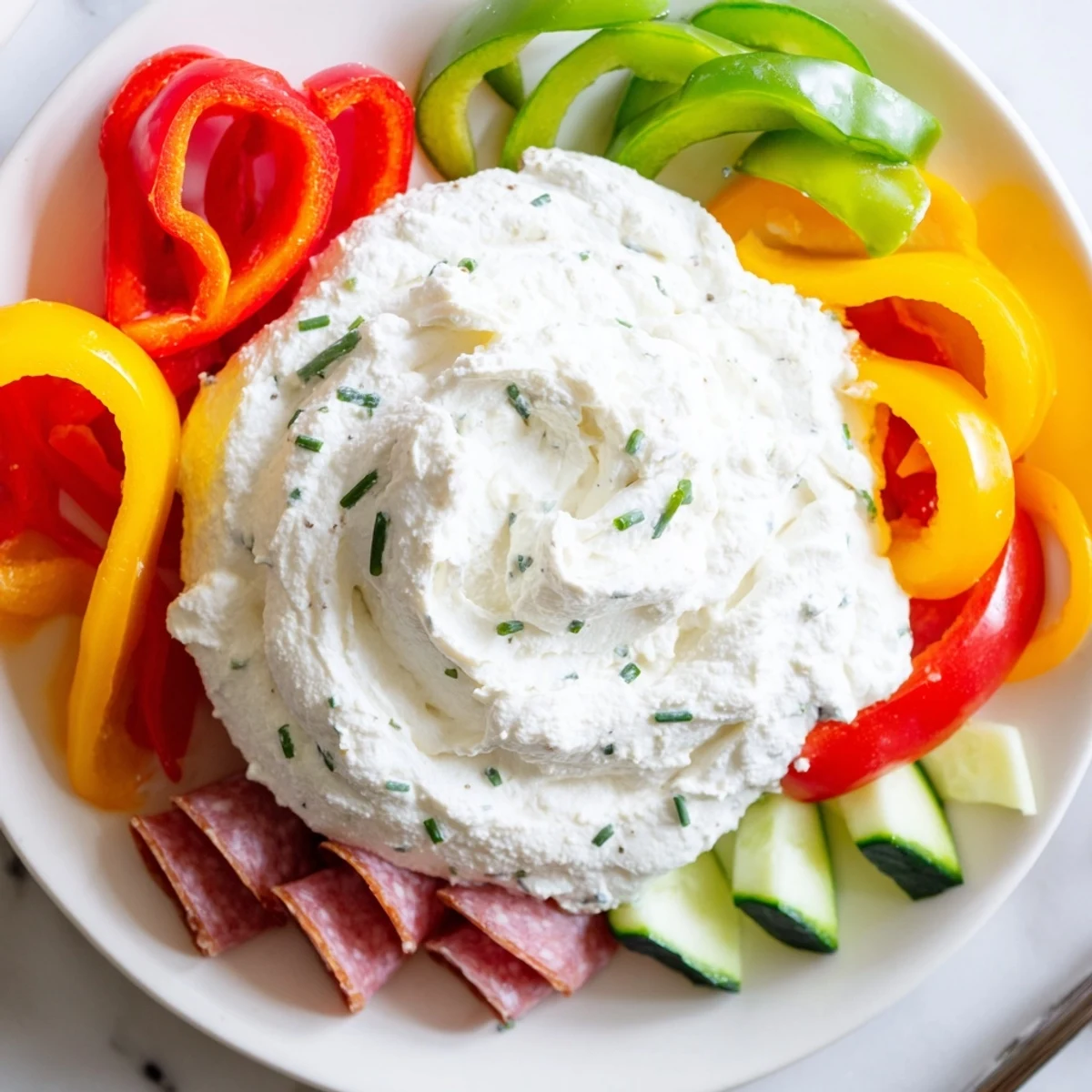 A delightful view of The Medusa Curls: savory meat curls and vegetable tendrils dance around a creamy dip.