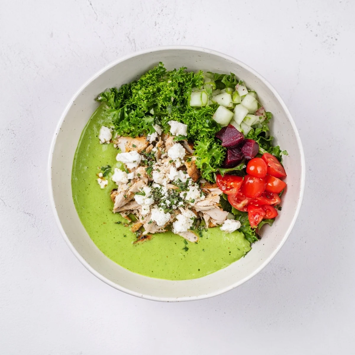 Creamy Green Goddess Chicken Nacho Dip with shredded chicken, herbs, and vibrant, fresh vegetables.