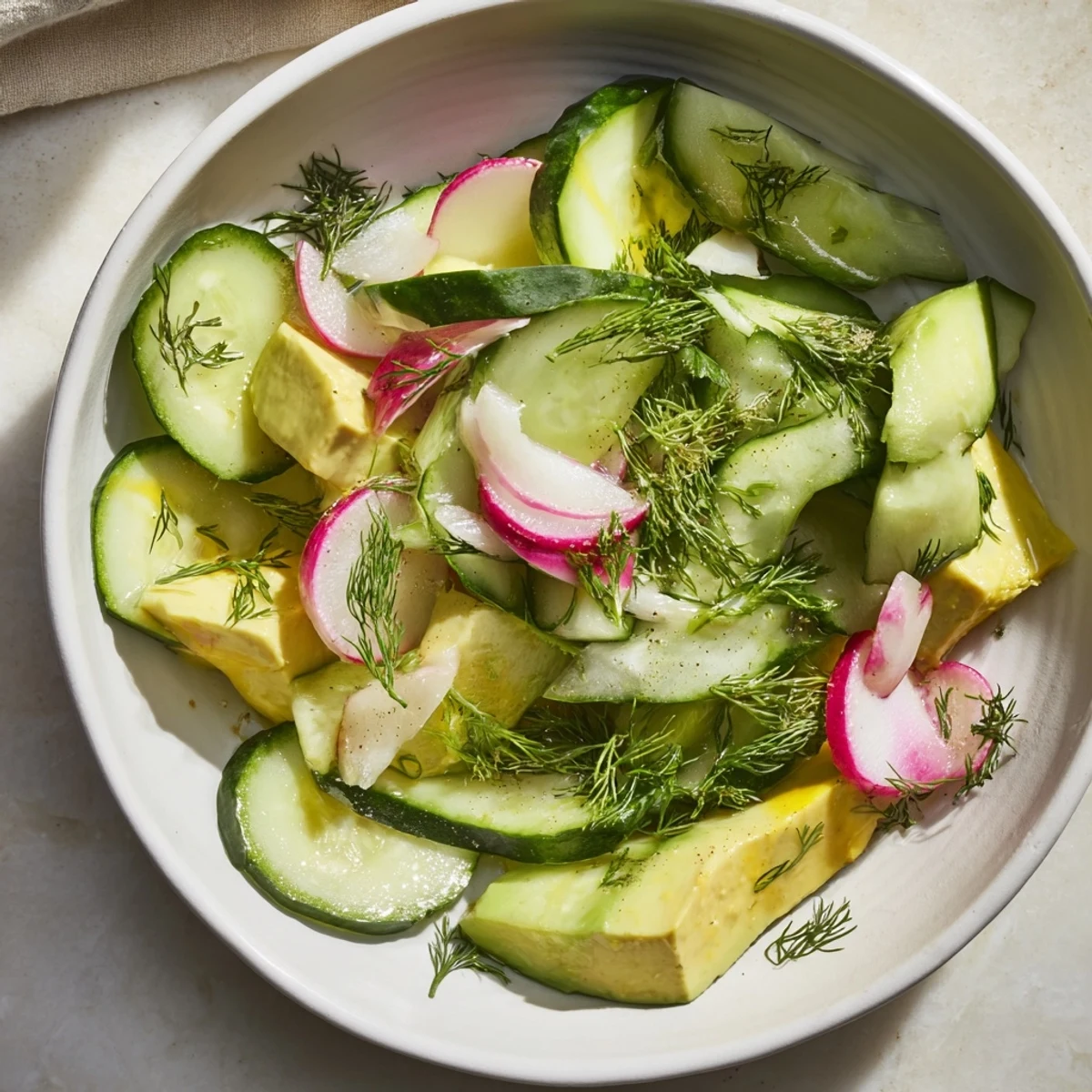Vibrant Cucumber and tinned fish date night salad, a pescatarian delight, layered and dressed to perfection.
