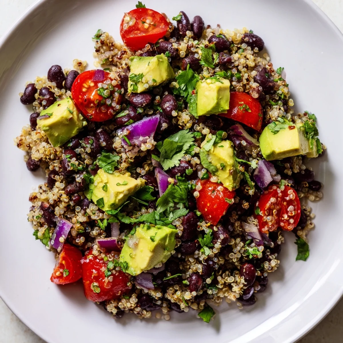 A colorful bowl of Quinoa Black Bean Salad with fresh vegetables, ready to serve.
