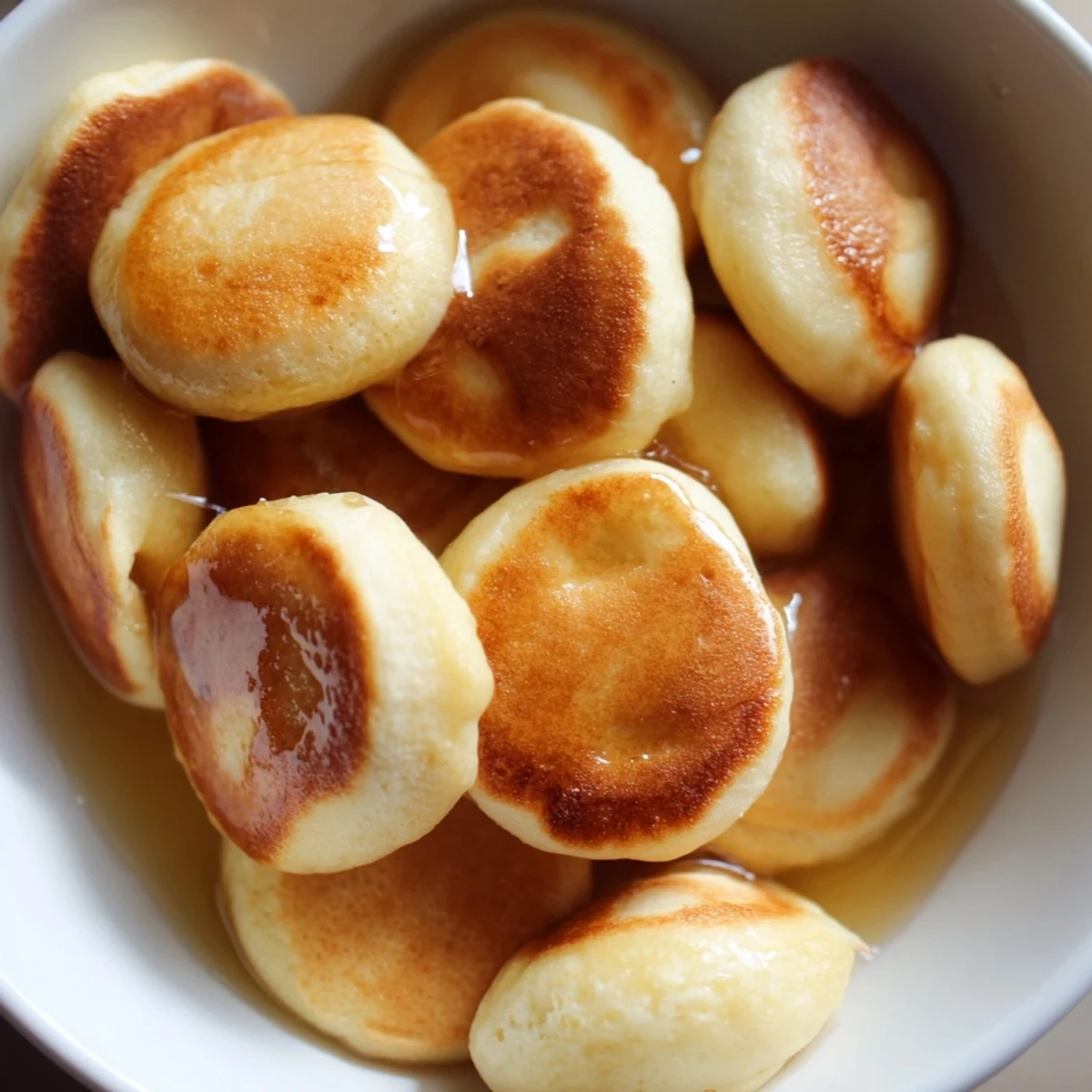 Imagine tiny, perfect fluffy pancake cereal, ready to be enjoyed with milk—delicious breakfast!