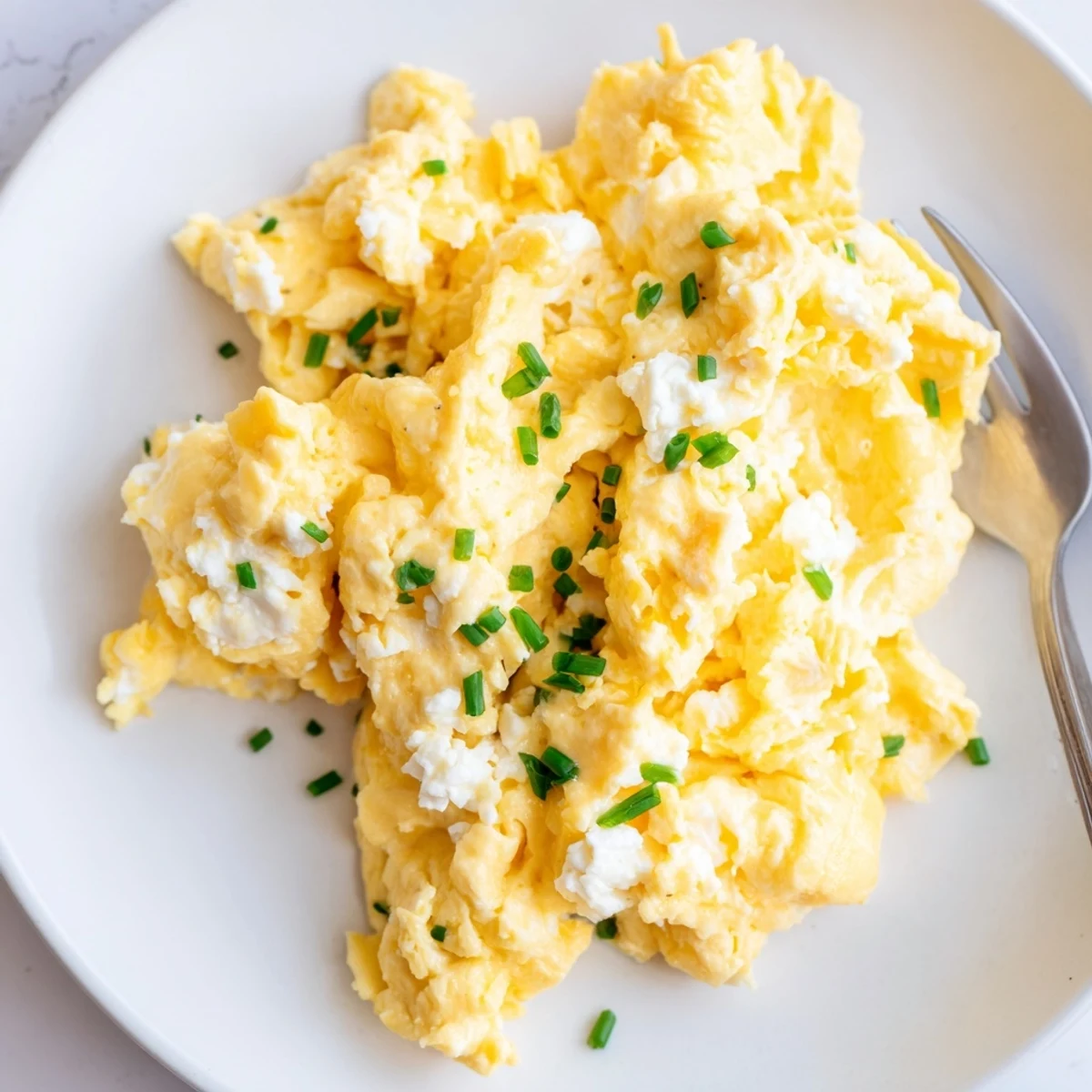 Golden-yellow Cottage Cheese Scrambled Eggs, cooked on the stove, perfect for brunch.