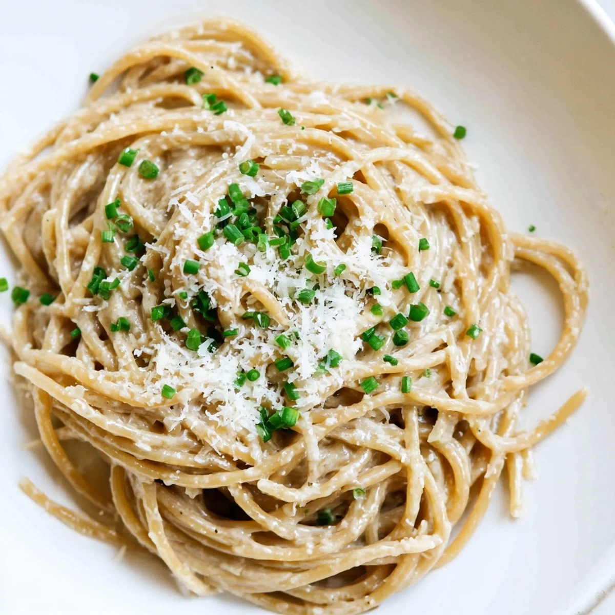 Close-up of creamy miso butter pasta, with perfectly coated spaghetti glistening in the skillet.