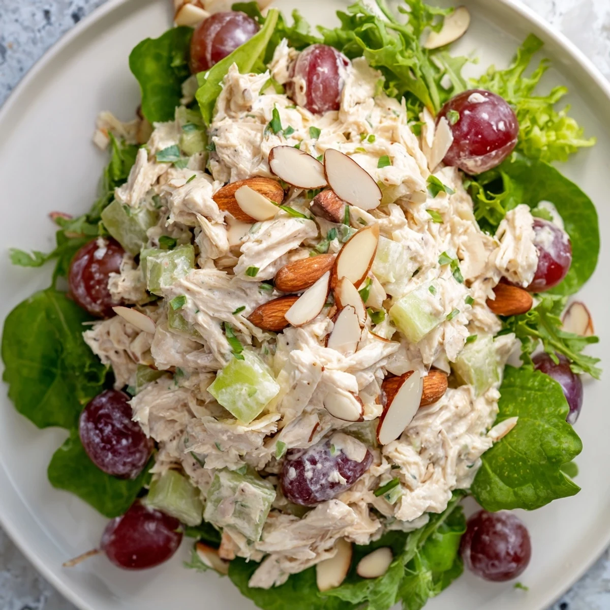 A delicious, creamy Crispy Chicken Salad with juicy grapes and crunchy celery piled on fresh greens.