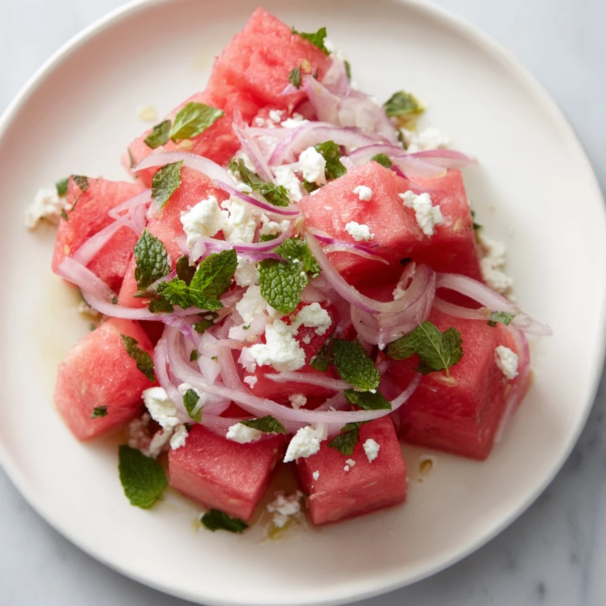 Close-up of Watermelon Feta Salad: Sweet watermelon, tangy feta, and a minty lime dressing.