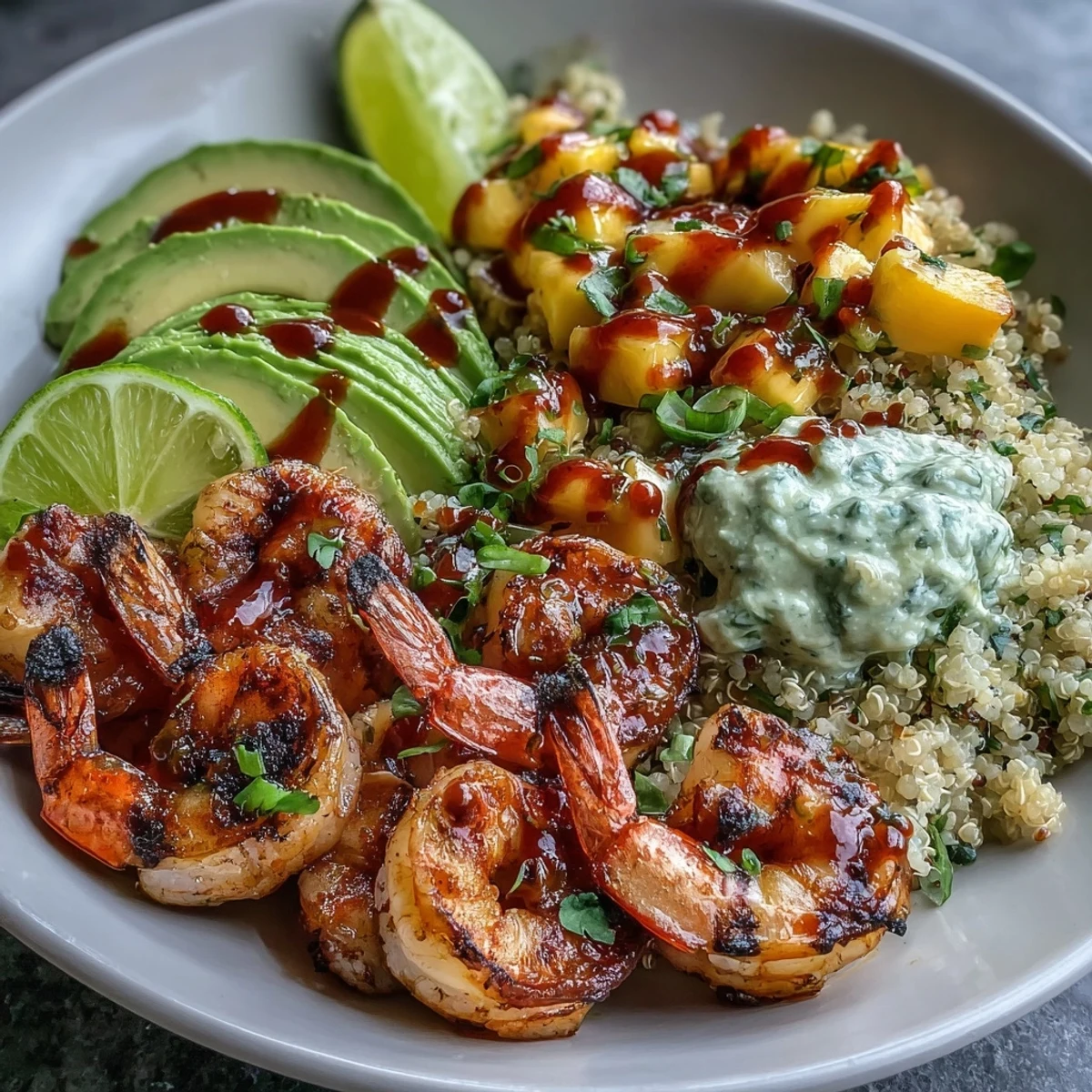 Close-up of Fresh Shrimp and Creamy Avocado Bowls with Zesty Mango Salsa and Lime Chili Sauce highlighting juicy shrimp, creamy avocado, and mango.