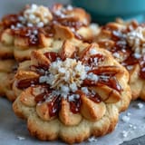 Beautiful flower-shaped shortbread cookies with golden edges, perfect for spring tea parties and elegant dessert trays.
