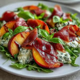 Savory prosciutto salad featuring ripe peaches and fresh basil, perfectly dressed.