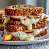 Gooey Peach Hot Honey Grilled Cheese, sweet fruit and spicy honey drizzled.