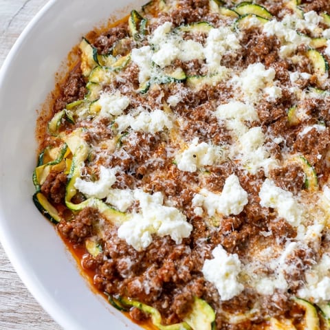 Skillet of bubbling Zucchini Lasagna, loaded with cheese, ground beef, and layered zucchini ribbons.