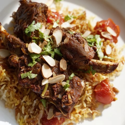 Fluffy white rice topped with tender lamb, this Qatari Majboos smells wonderfully of spices.
