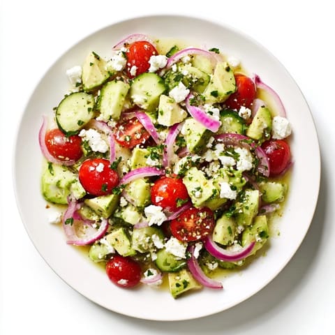 Bright red tomatoes and creamy avocado star in this easy Fresh Salad with feta cheese.