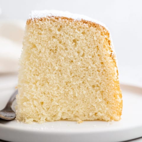 A fluffy slice of 3-Ingredient Vanilla Sponge Cake, moist and perfect with coffee.