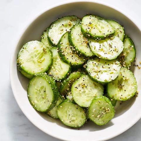 Vibrant image of a Cucumber Shaker, glistening with seasoning, a perfect low-carb, quick American snack.