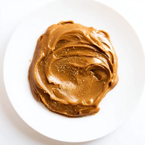 A creamy spoonful of Emirati Al Madrooba: Sweet dates and ghee, a flavorful Emirati breakfast.