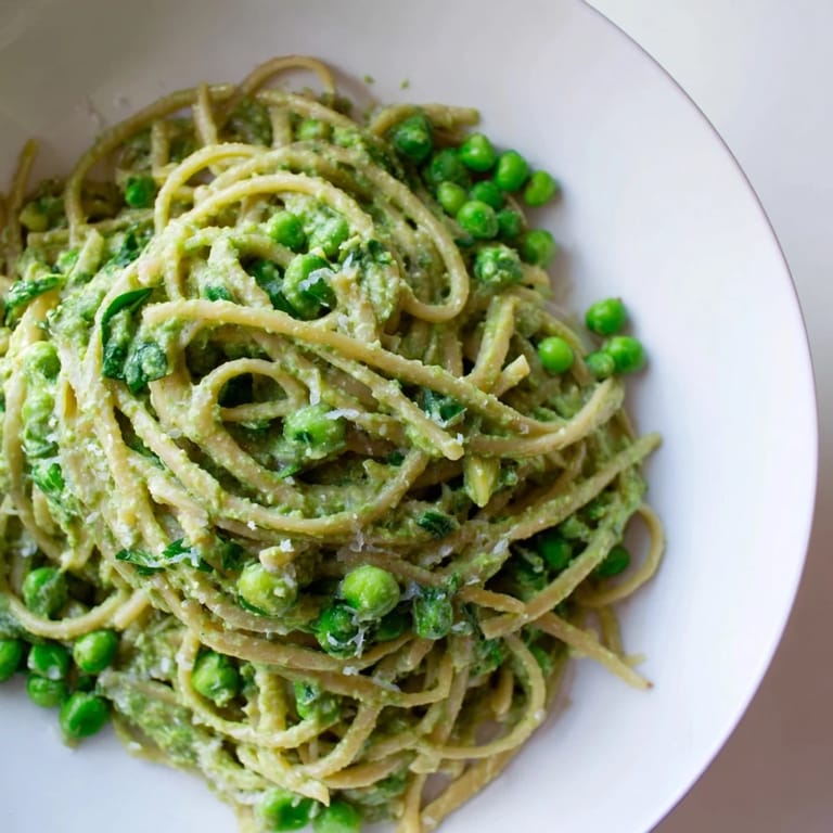 Bright green green goddess pasta, ready to enjoy, with visible herbs and a creamy texture.