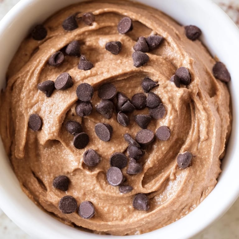 A close-up of Gluten-Free Brownie Batter Dip, with chocolate chips and a rich, decadent texture.