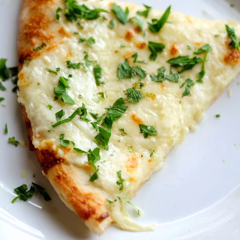 Freshly baked Creamy Garlic White Pizza with herbs, ready to serve with a glass of chilled white wine.