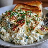 Creamy cottage cheese scrambled eggs with fluffy texture and rich protein, served in a skillet for a hearty breakfast.  