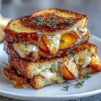Peach Hot Honey Grilled Cheese with melted cheese and golden crispy bread.